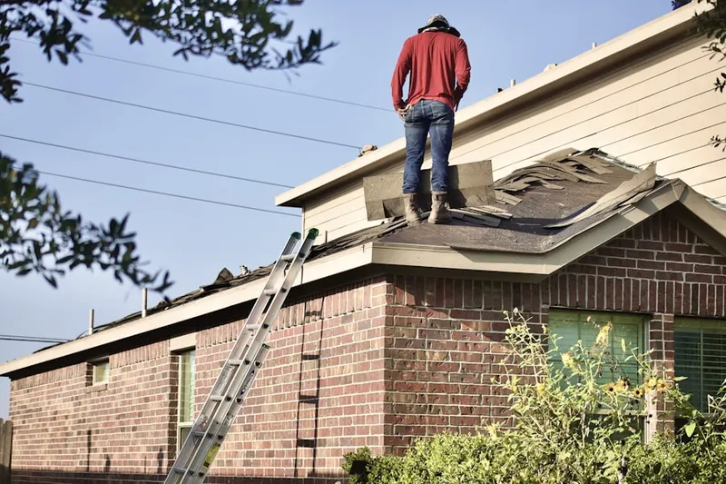 Professional roofer working on a residential roof in Royal Northaven
